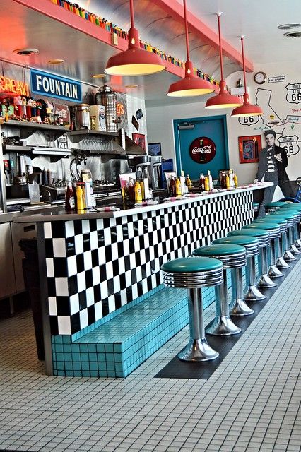 a restaurant with checkered counter tops and blue benches