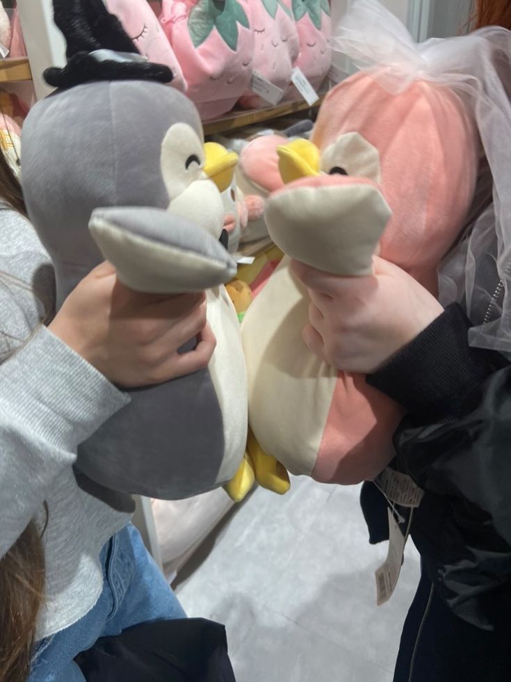 two girls holding stuffed animals in their hands