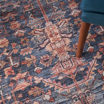 a blue chair sitting on top of a rug