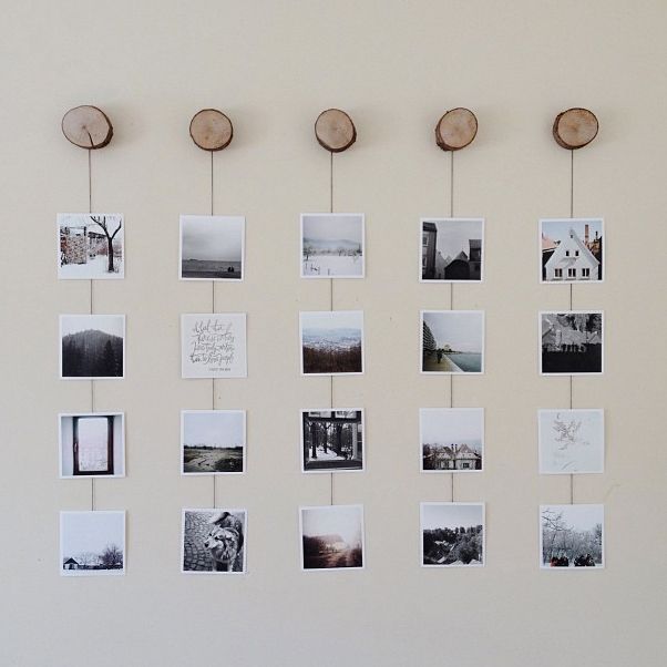 there are many pictures hanging on the wall with wooden circles attached to them and some wood slices