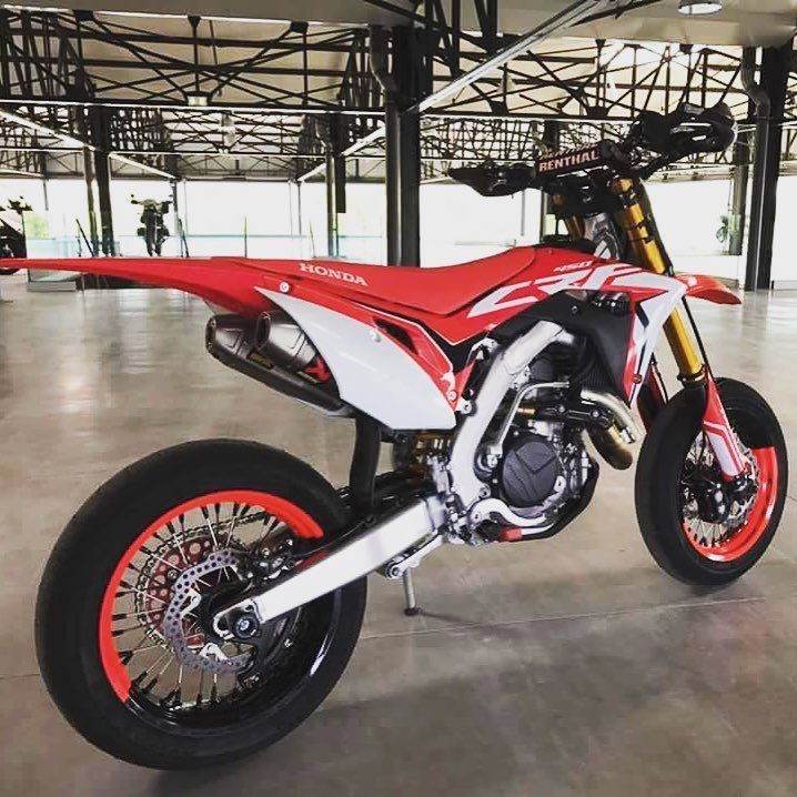 a red and white motorcycle parked in a garage