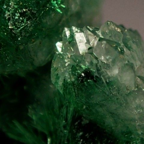 some green crystals sitting on top of each other