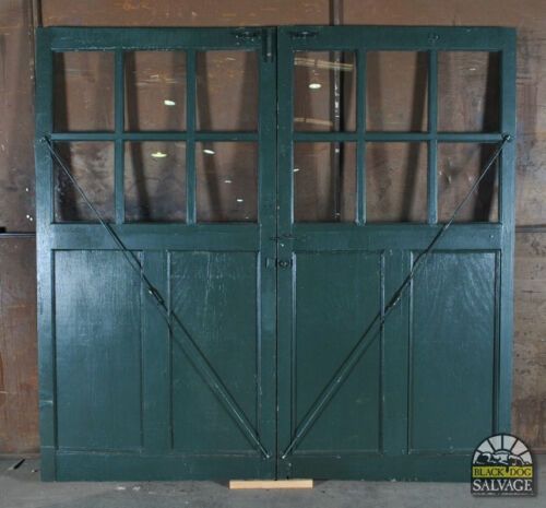 an old green double door with glass panes