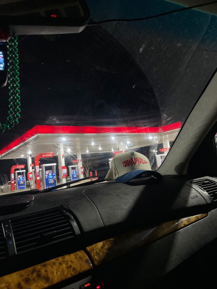 the interior of a gas station is lit up with christmas lights and garlands hanging from the ceiling