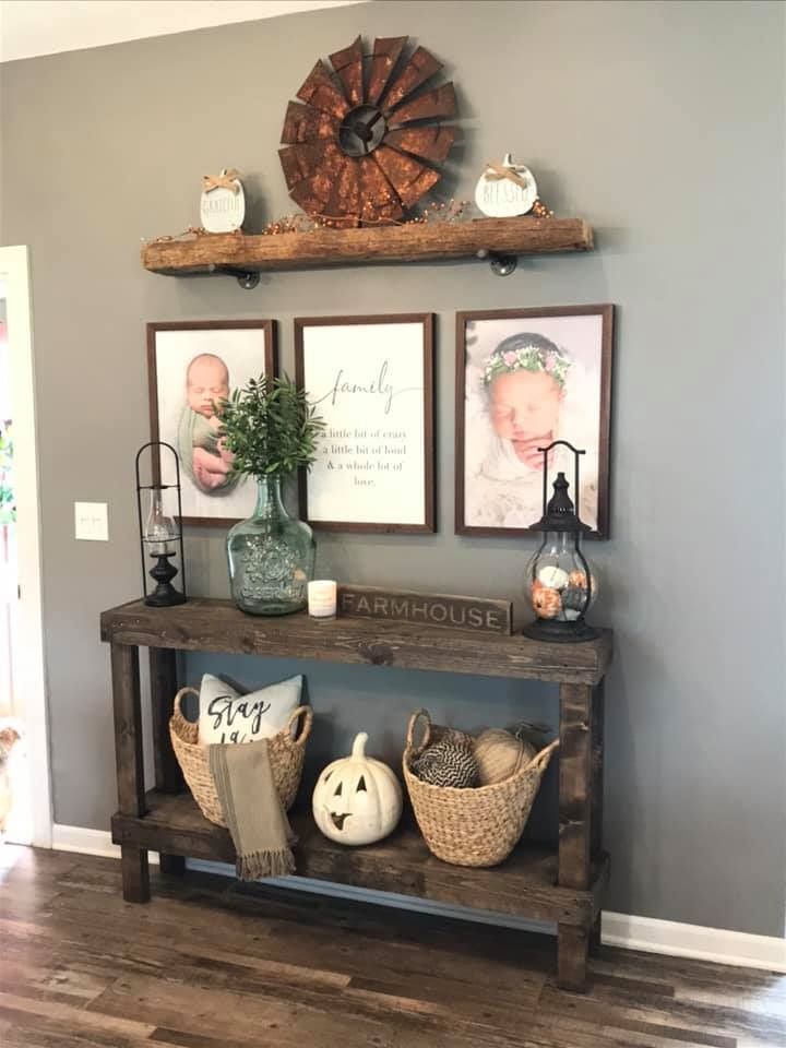 a wooden shelf with baskets and pictures on it