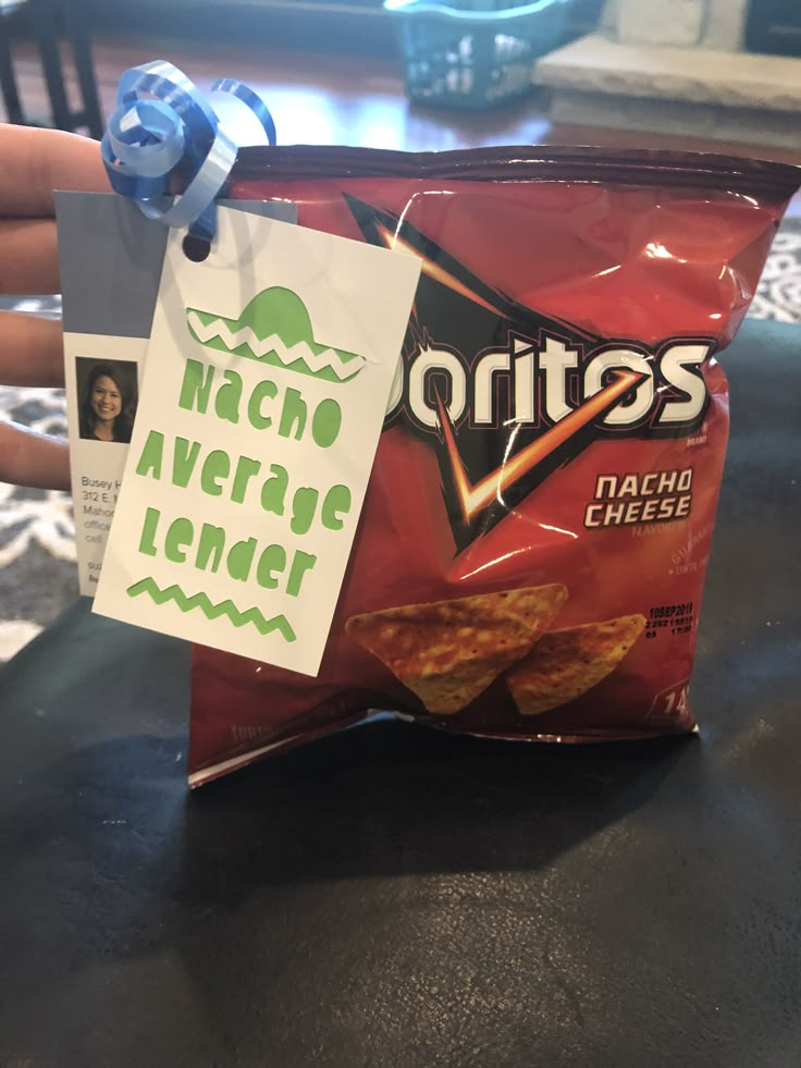 a bag of nachos is sitting on a table with a note attached to it