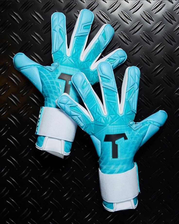 a pair of blue and white gloves sitting on top of a metal surface