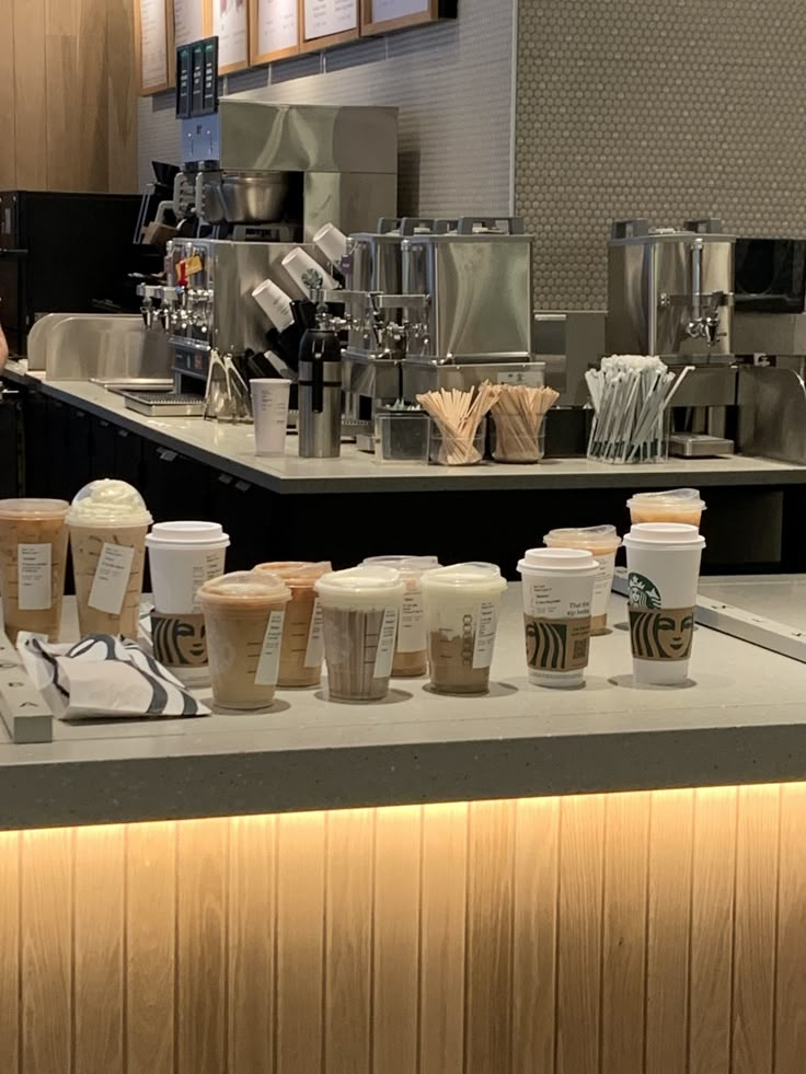 coffee cups are lined up on the counter