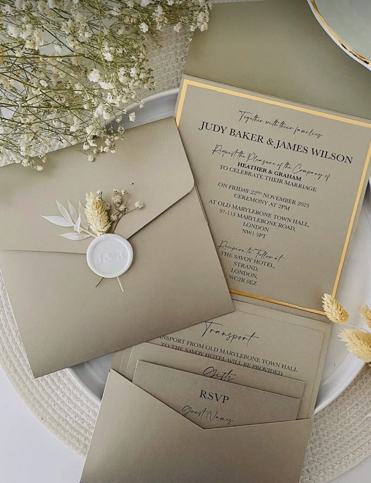 the wedding stationery is laid out on a plate