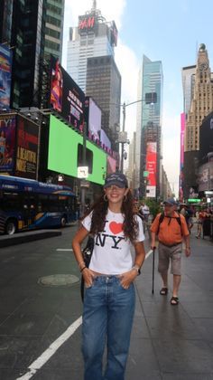 a woman standing in the middle of a city street