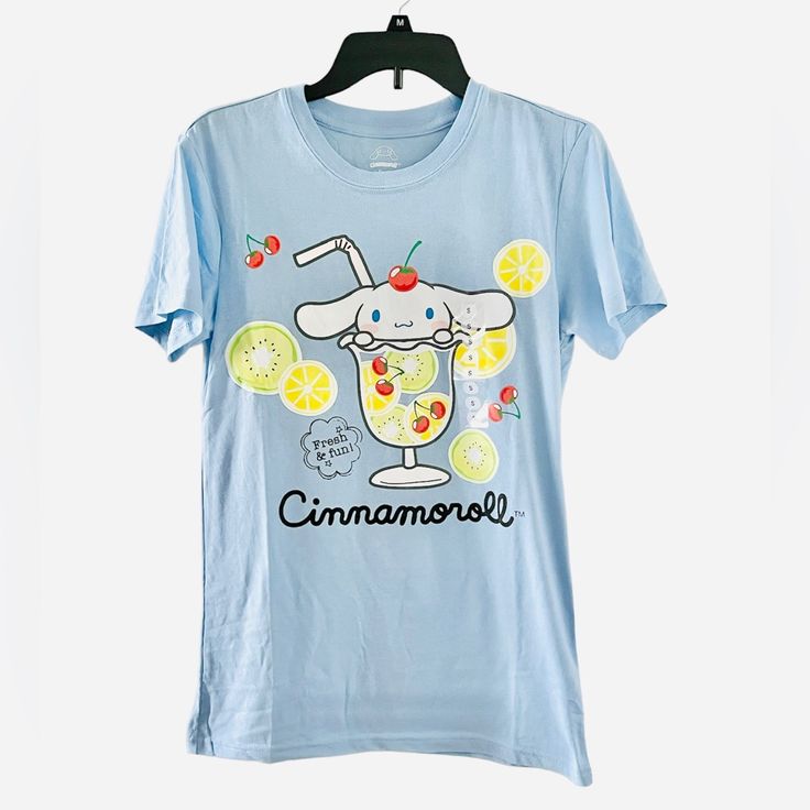 Sanrio Cinnamoroll Fruit Cup Graphic “Fresh Fun” T-Shirt (Baby Blue) Condition: Brand New With Tags Defect To Large Size: Excess Fabric Per Manufacture (See Photo Set) Note: Please View All Photos Carefully For Item Description And Note That A Large Is Pictured. Defect If Manufacturing Is Only Shown On The Photo Set For The Large Size. Thank You. Cute Blue T-shirt For Loungewear, Light Blue T-shirt With Cartoon Print For Spring, Blue Kawaii Summer Tops, Blue Kawaii Top For Summer, Kawaii Blue Tops For Summer, Blue Kawaii Tops For Summer, Light Blue Cartoon Print T-shirt For Spring, Light Blue Cartoon Print Top For Summer, Light Blue Cartoon Print Summer Tops