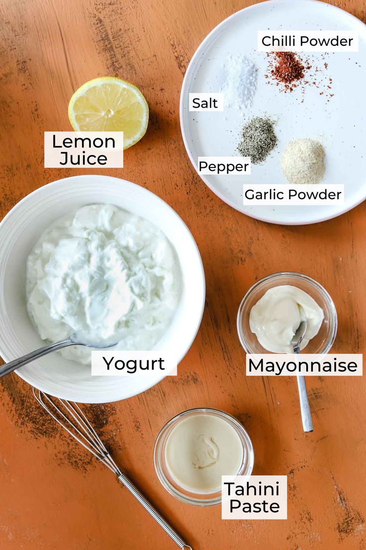 the ingredients to make mayonnaise on a wooden table with spoons and bowls