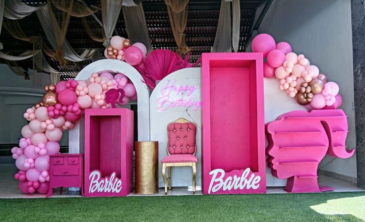 pink and gold decorations are on display at a barbie birthday party