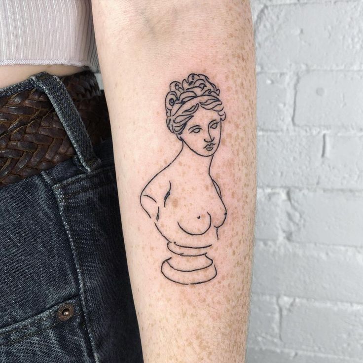 a woman's arm with a small tattoo on the left side of her body