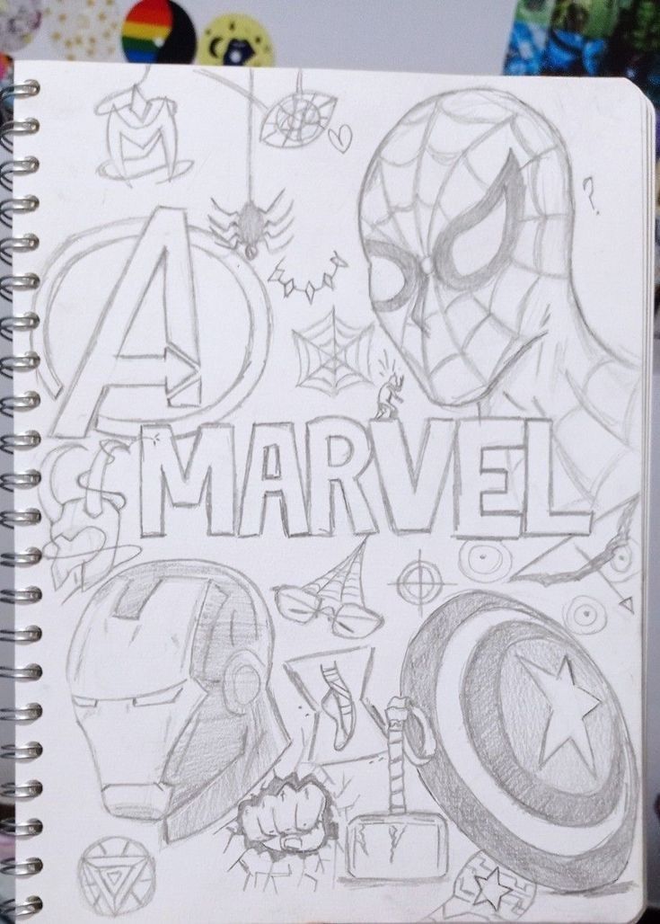 a notebook with the words avengers and captain america drawn on it, in front of various cartoon characters