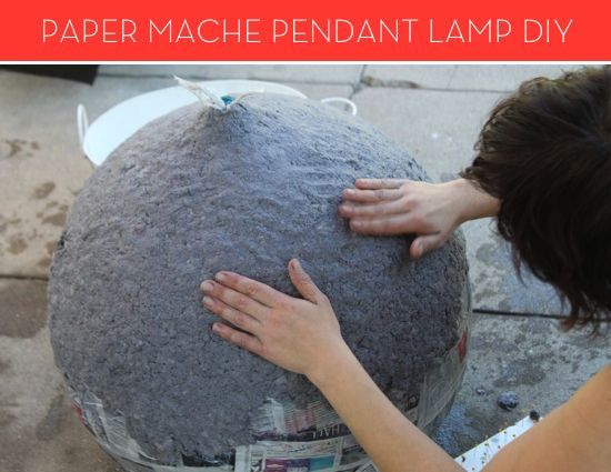 a woman is holding her hands on the top of a large object that looks like a ball