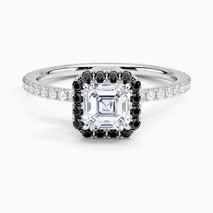 an engagement ring with black and white diamonds