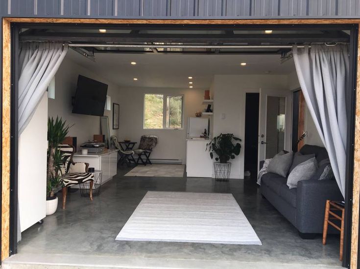 an open garage door showing the living room and kitchen