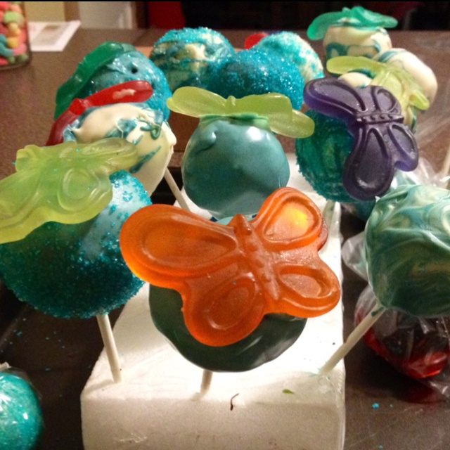 there are many candy candies in the shape of flowers and butterflies on this table