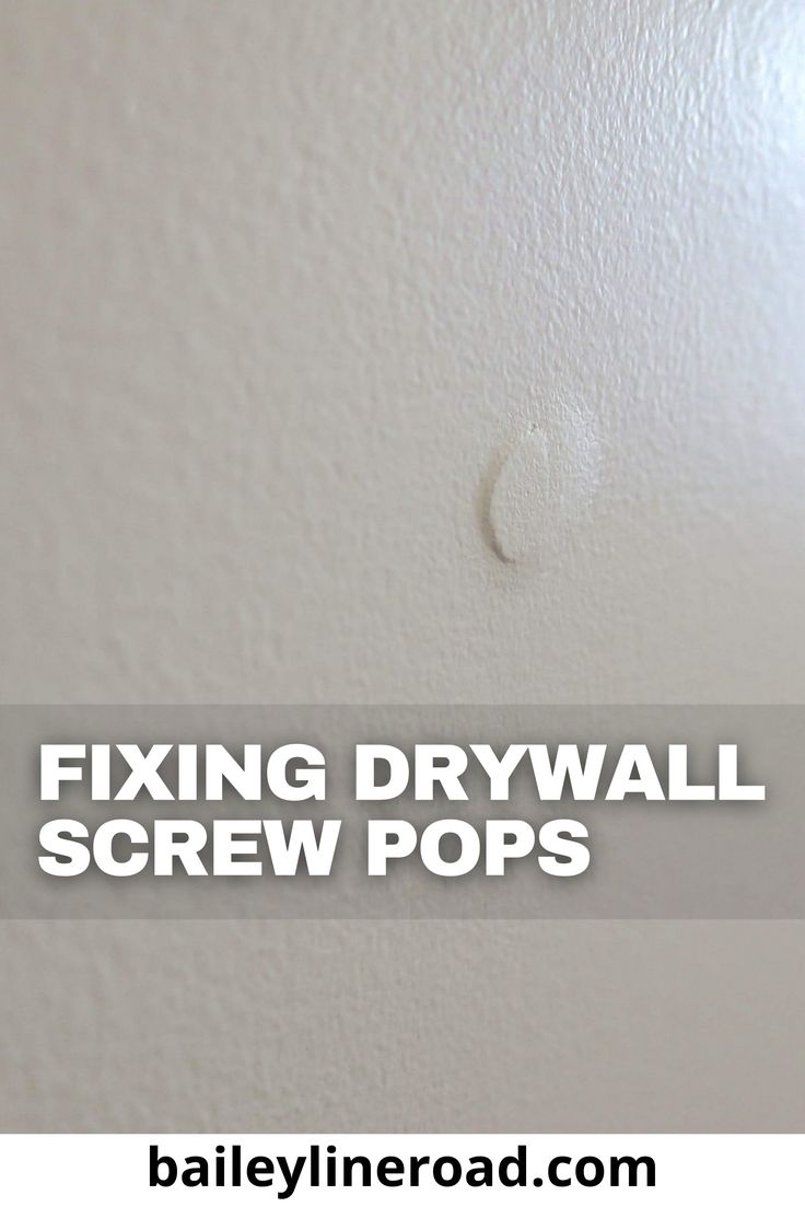 fixing drywall screws on the wall in a room with text overlay that reads fixing drywall screw pops