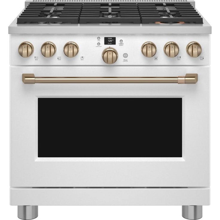 a white oven with gold knobs and two burners on the front, and an oven