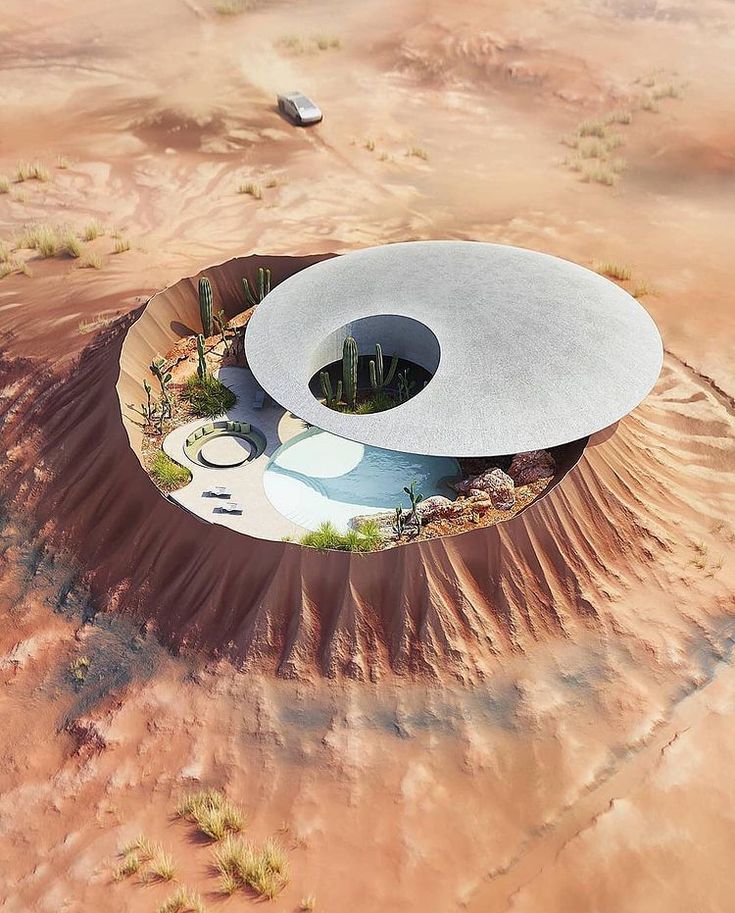 an aerial view of a building in the middle of some desert with no people around it