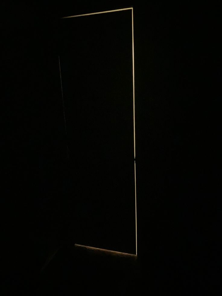 an open door is shown in the dark