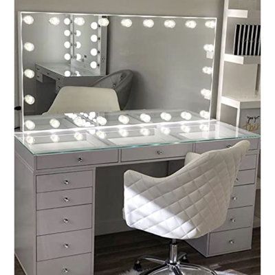 a desk with a chair, mirror and lights on it