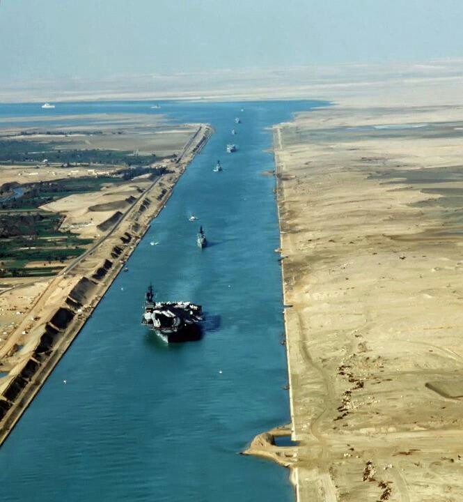 an aerial view of a waterway with boats in the water and dirt land around it