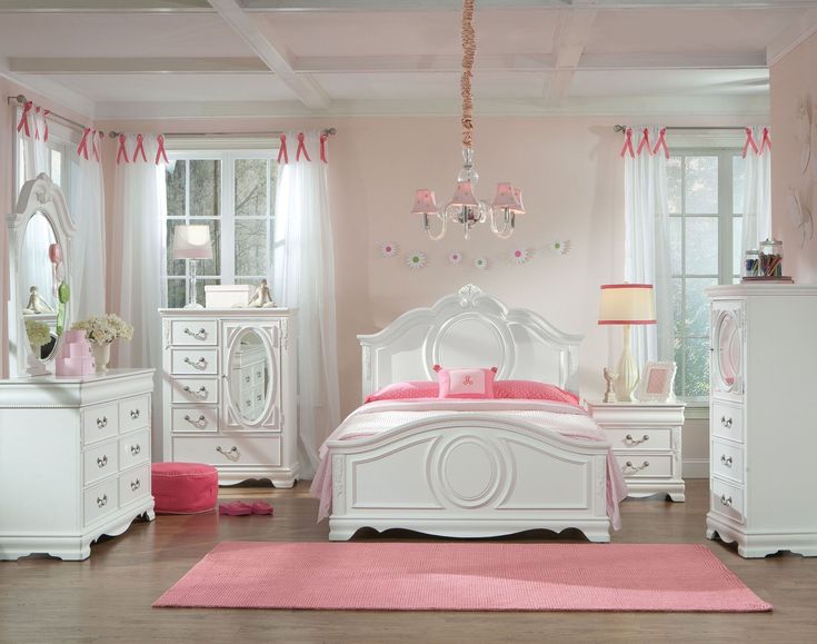 a bedroom with pink walls and white furniture