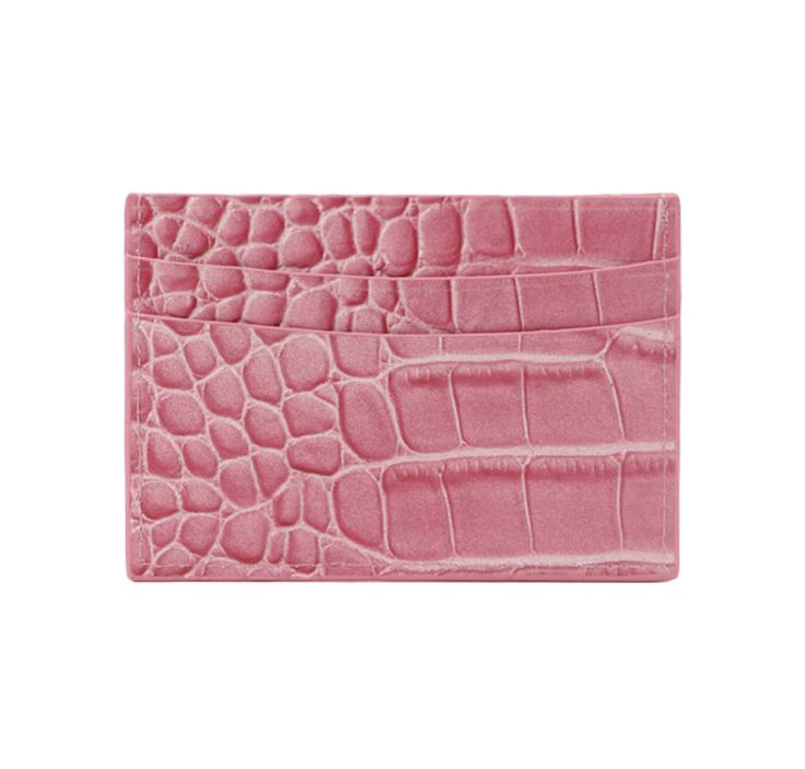 a pink alligator skin card case on a white background