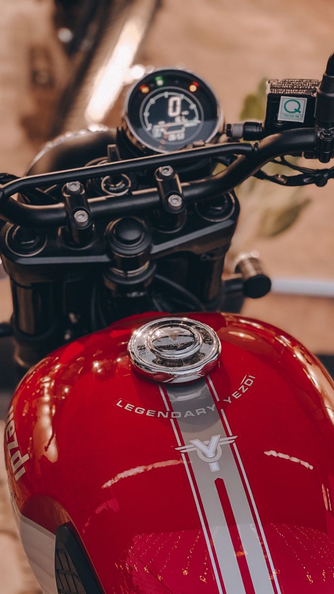 a close up of the handlebars on a red motorcycle