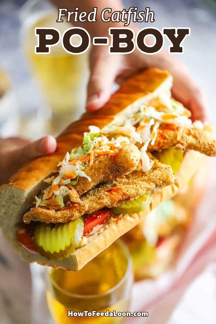 a person holding a sandwich in their hand with the words fried catfish po - boy on it