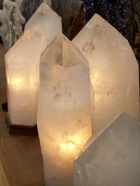 some very pretty looking crystals on a table with lights in it's centerpieces