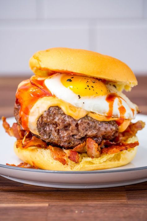 an egg and cheese burger on a plate