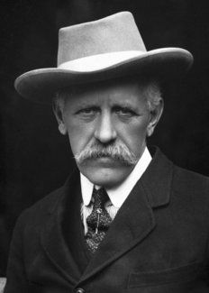 a man with a mustache wearing a suit and hat