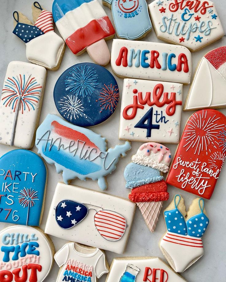 decorated cookies are arranged in the shape of american flags and other patriotic items for fourth of july