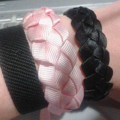 three different types of bracelets sitting on top of a person's arm with a laptop in the background