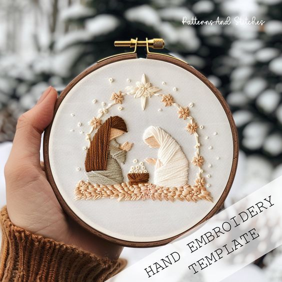 a hand embroidered christmas ornament with a woman and child sitting in the snow