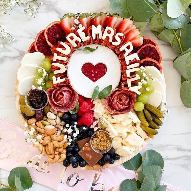 a cake decorated with fruit and nuts on top of a table