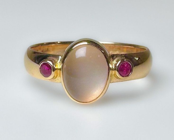 Stunning vintage, midcentury to 1970s...not entirely sure of its age. It does have an older hallmark. This is elegantly crafted ring with a comfortable low profile.  Featuring a clean luminescent 1.5ct Moonstone, flanked by two red Ruby's. Very pretty ring. 3.7g 14k solid yellow gold Hallmarked 4mm wide band Moonstone 1.5 ct Rubies 2 mm ea (.10ct) S 8 Us Resizable Excellent vintage condition Unique Ring Setting, Moonstone Gold Ring, Signet Rings Women Vintage, Vintage Ruby Ring, Ruby Ring Vintage, Rubin Ring, Moonstone Rings, June Birthstone Ring, Signet Ring Men