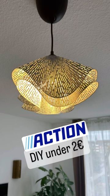 a light fixture hanging from the ceiling in a room with a sign that says action diy under 26