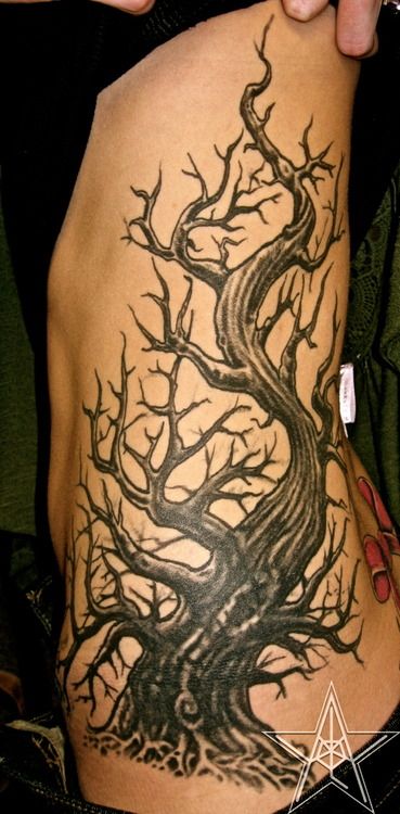 a woman with a tree tattoo on her back