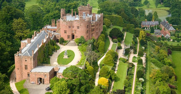 an aerial view of a castle in the middle of trees