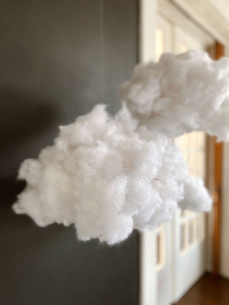 white clouds are floating in the air near a door