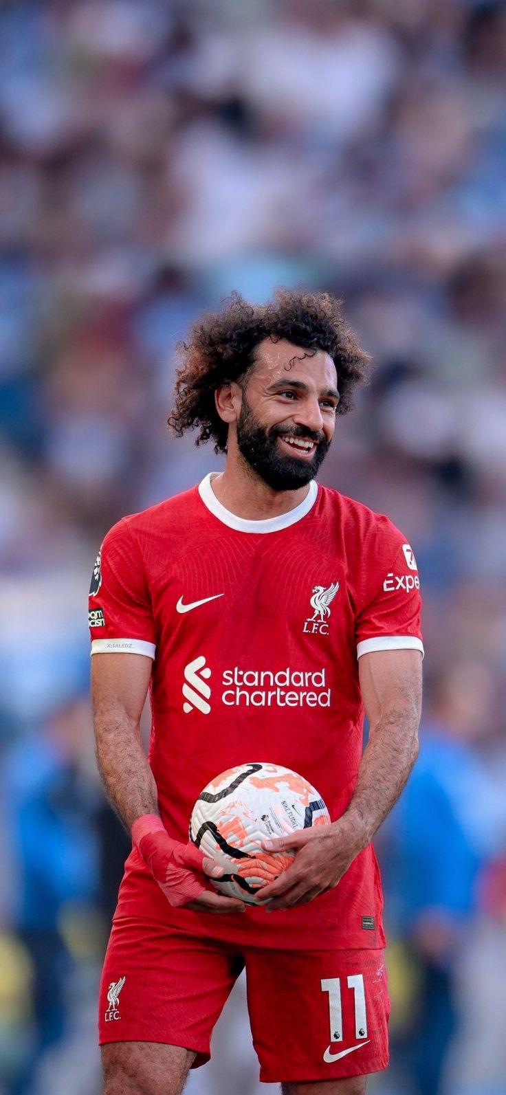 a man with a beard holding a soccer ball