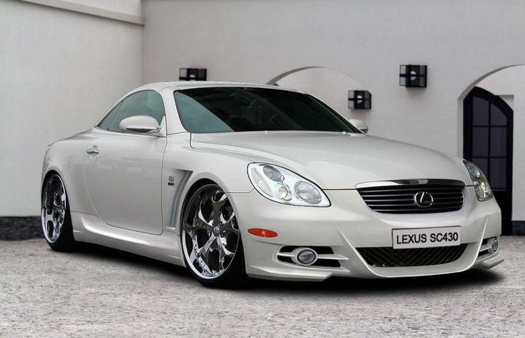 a white car parked in front of a building