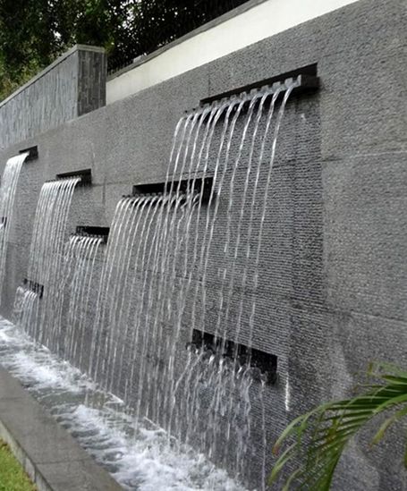 the water is running down the side of the building and it looks like they are falling