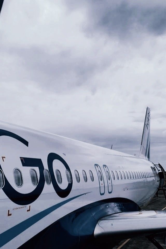 an airplane sitting on the tarmac at an airport