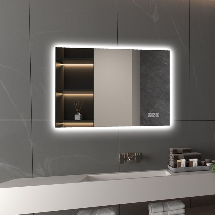 a bathroom with a sink, mirror and towels on the counter top in front of it